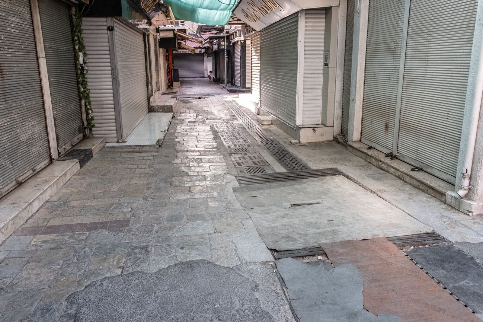 A deserted alley in İzmir with the roller doors of its shops pulled down.