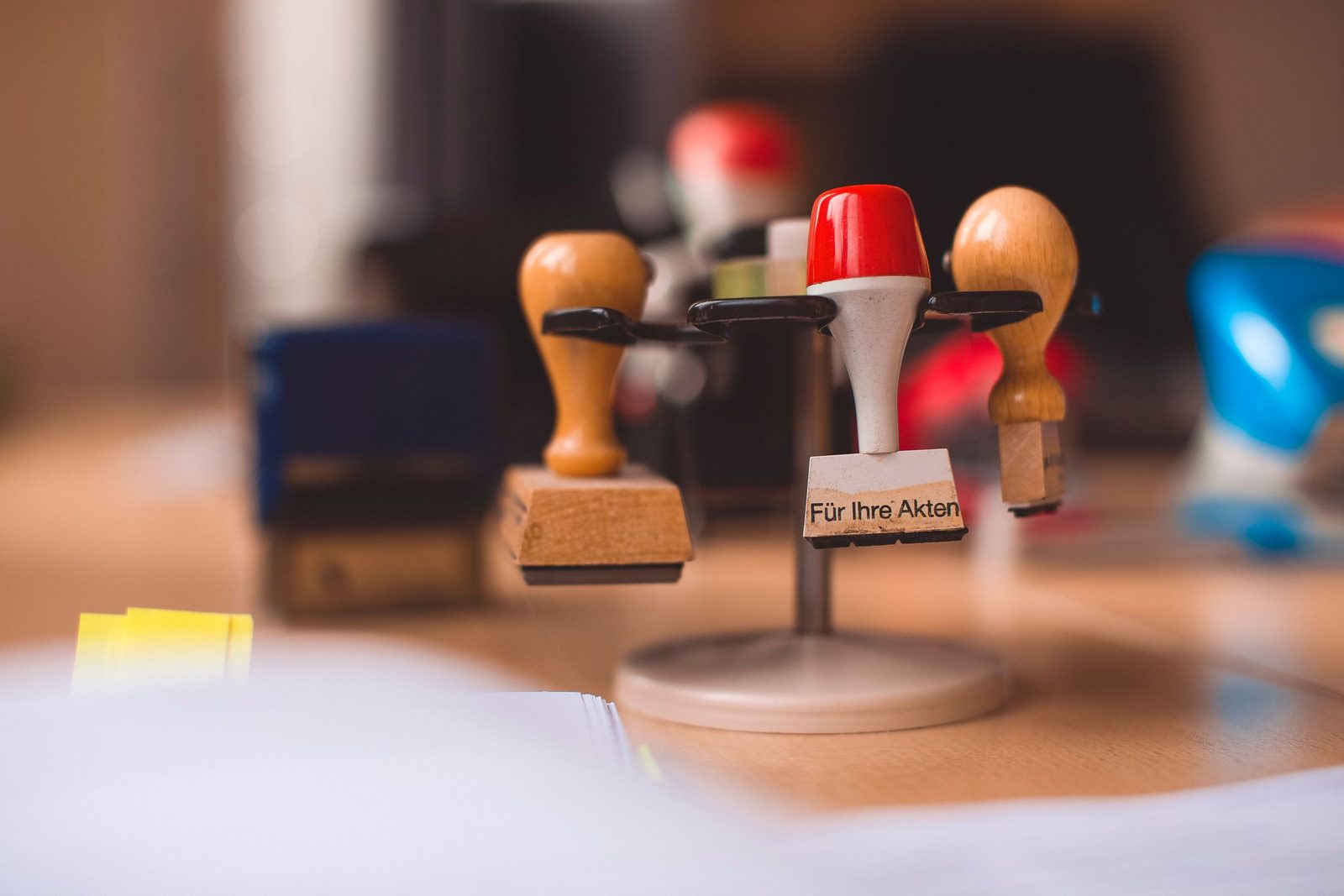A holder of rubber stamps on a wooden table.