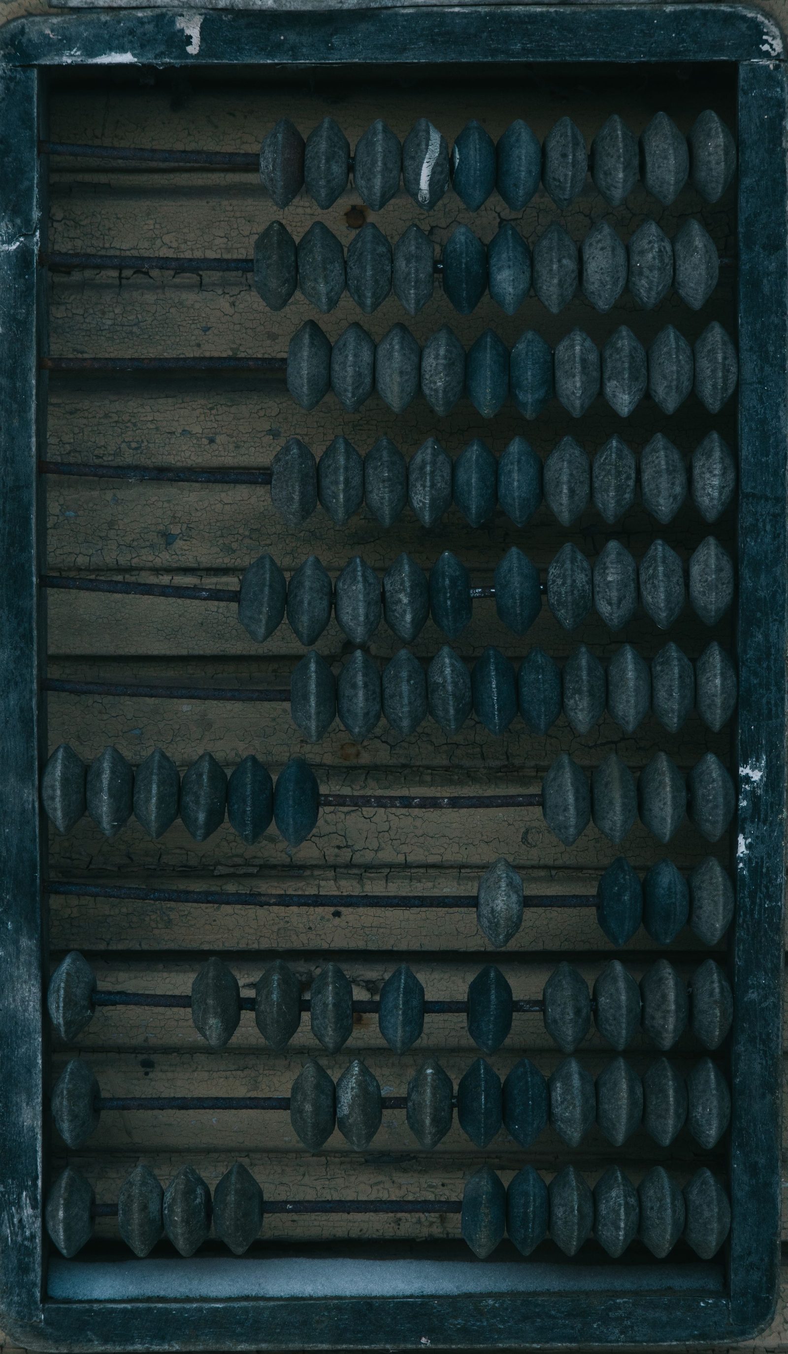 An old wooden abacus with weathered beads.