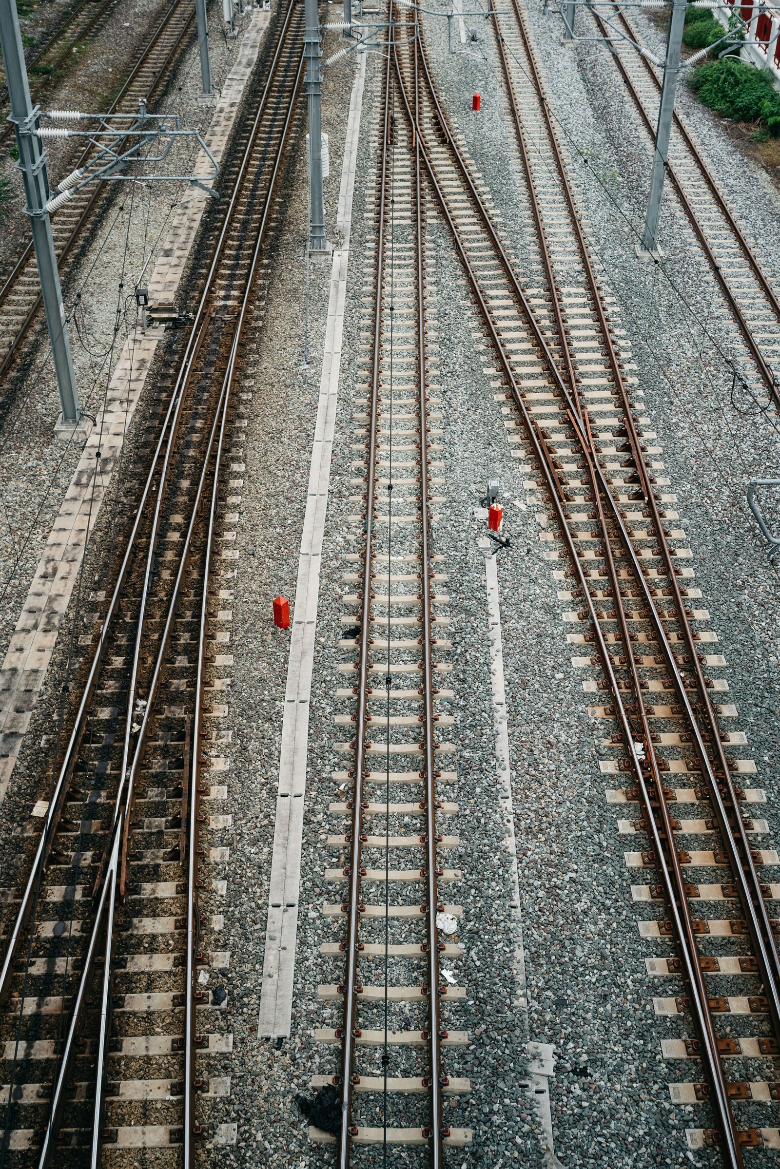 Railway tracks run in parallel and cross one another seen from directly above in Bangkok.