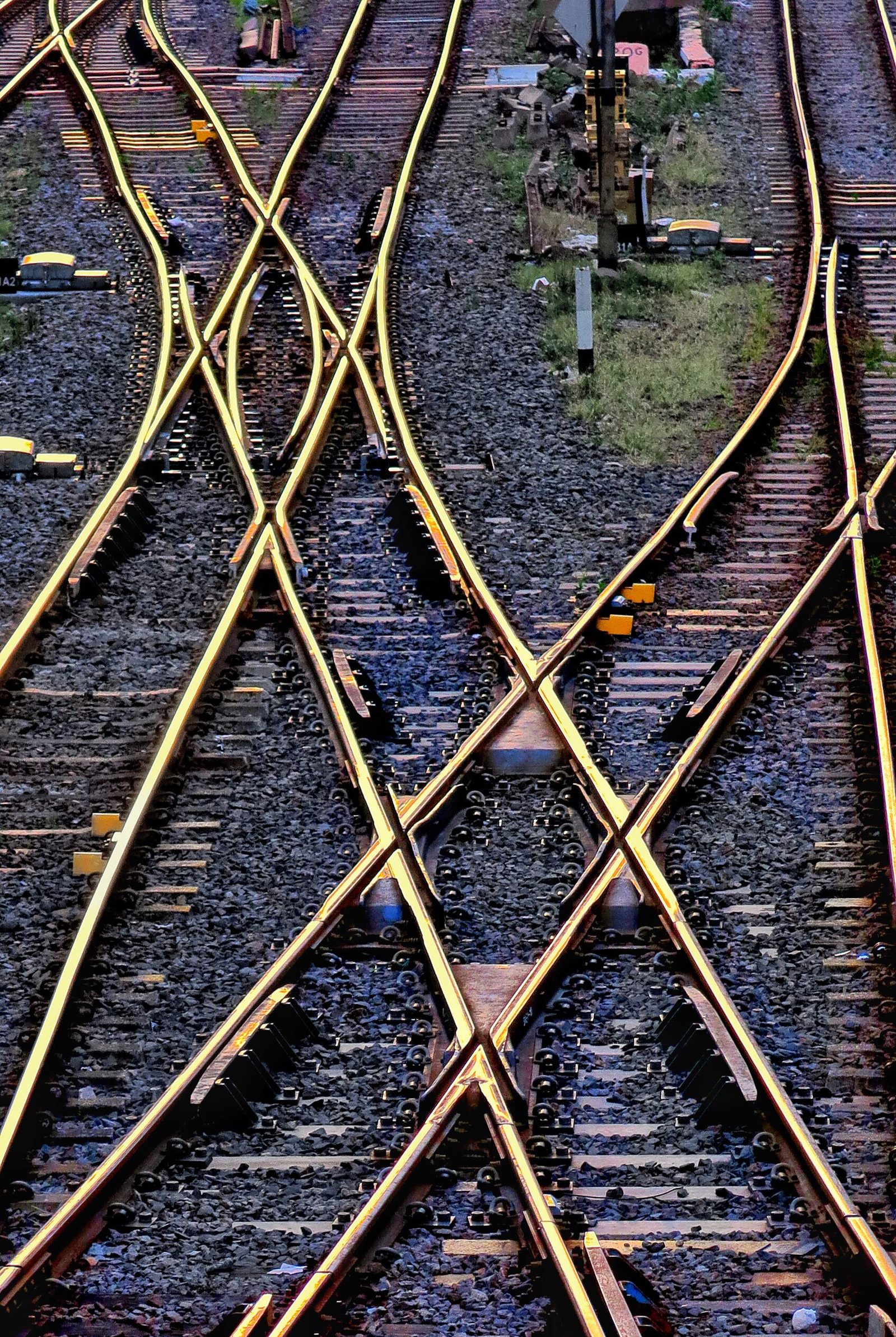 An aerial view of railway tracks crossing and branching in a city.
