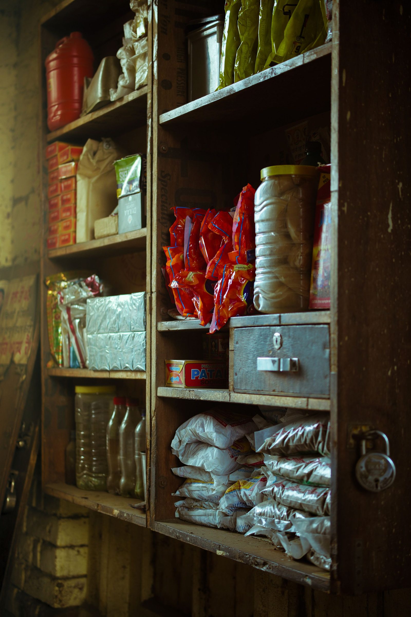 Shelves of small packaged goods fill a neighbourhood shop in Moga, Punjab.