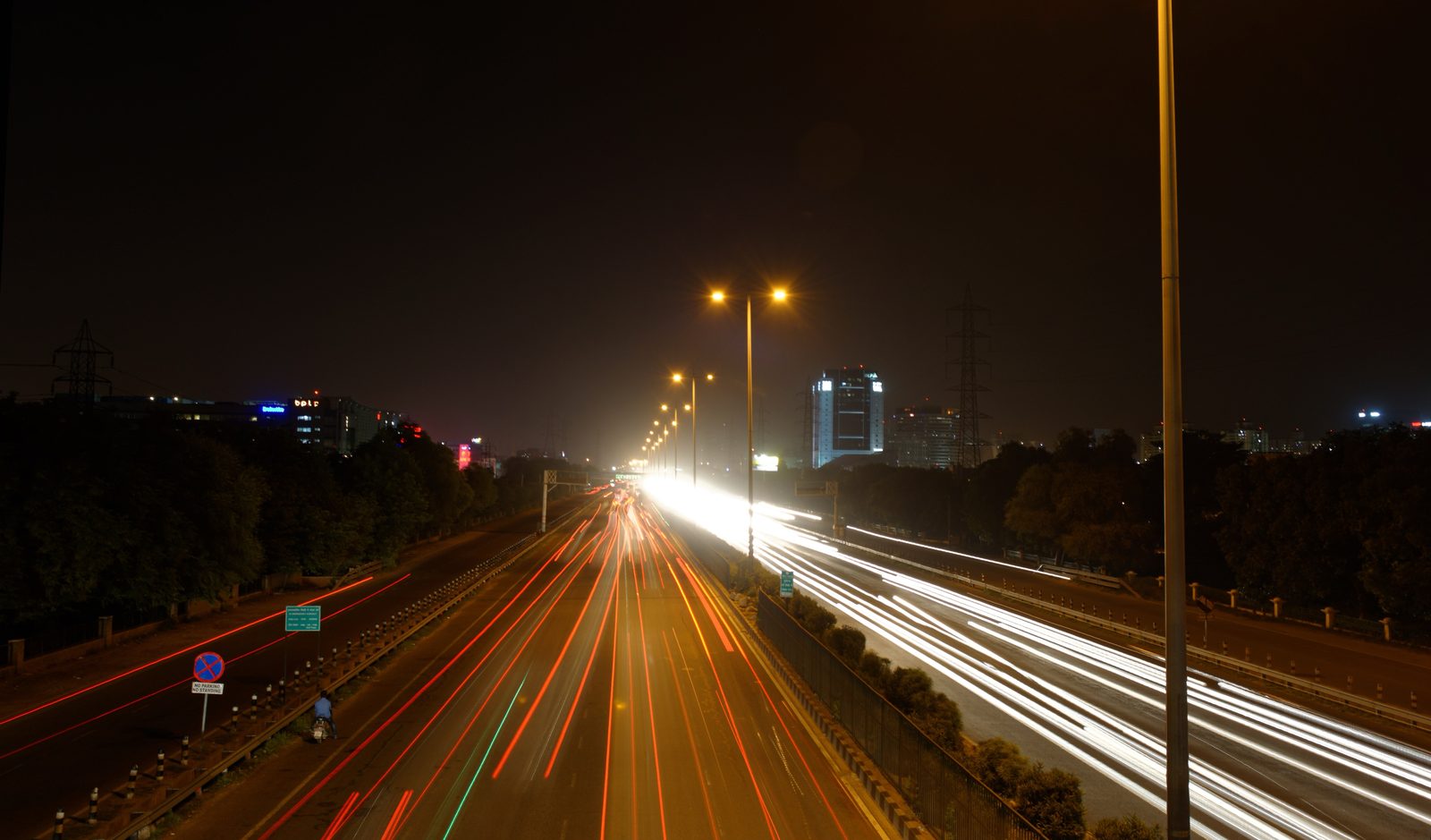 Streaks of white and red light from traffic on a wide highway at night, a long exposure