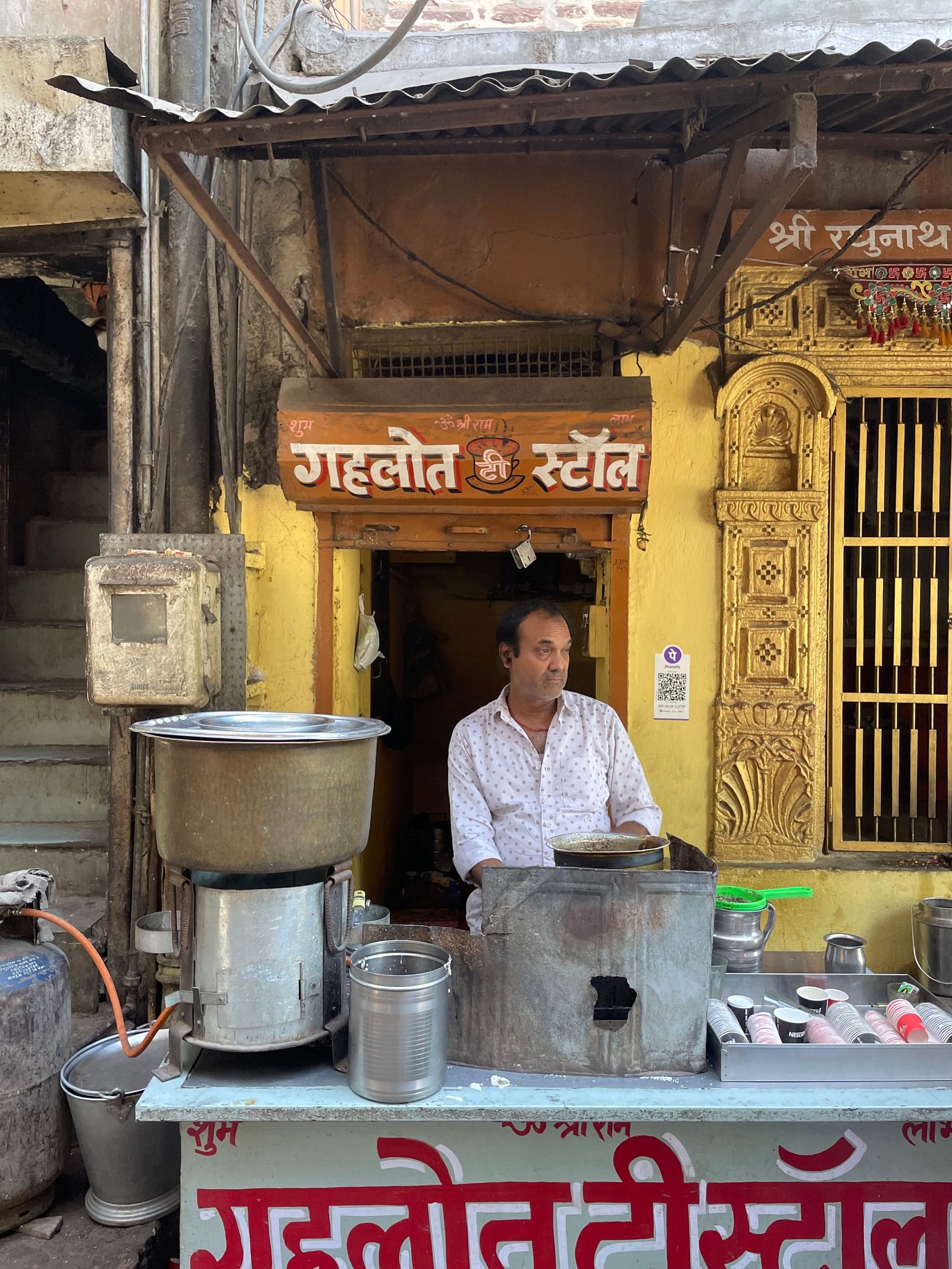 A vendor serves tea at a roadside stall on a street in Jodhpur.