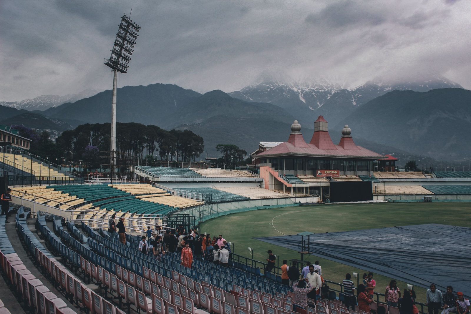 The HPCA cricket stadium in Himachal Pradesh sits beneath mountains and heavy cloud.