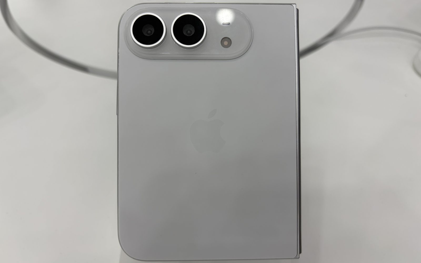 The back of a folded iPhone Duo in silver white with its two-camera module