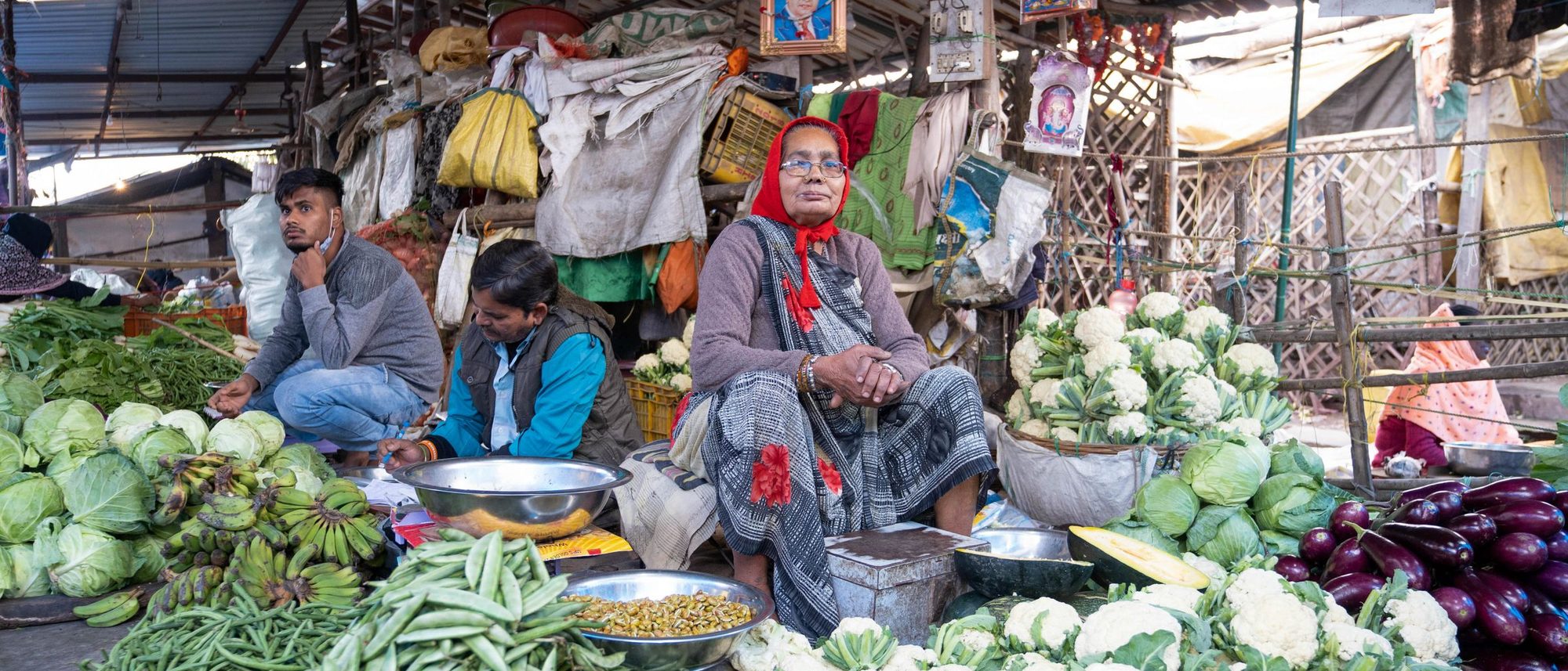 Heaps of fresh vegetables are laid out at an open-air market in India.