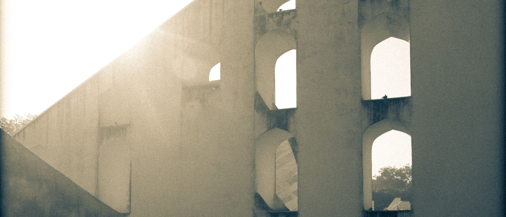 The stone instruments of the Jantar Mantar observatory in Jaipur in bright sunlight.